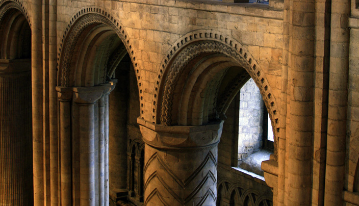 The Norman section of Durham Cathedral is characterised by its solidness, most notable in its robust columns and small, round-arched windows. In the two centuries that followed, architectural technology and consequently architectural conventions evolved greatly, making the Chapel of the Nine Altars, seen below, possible.